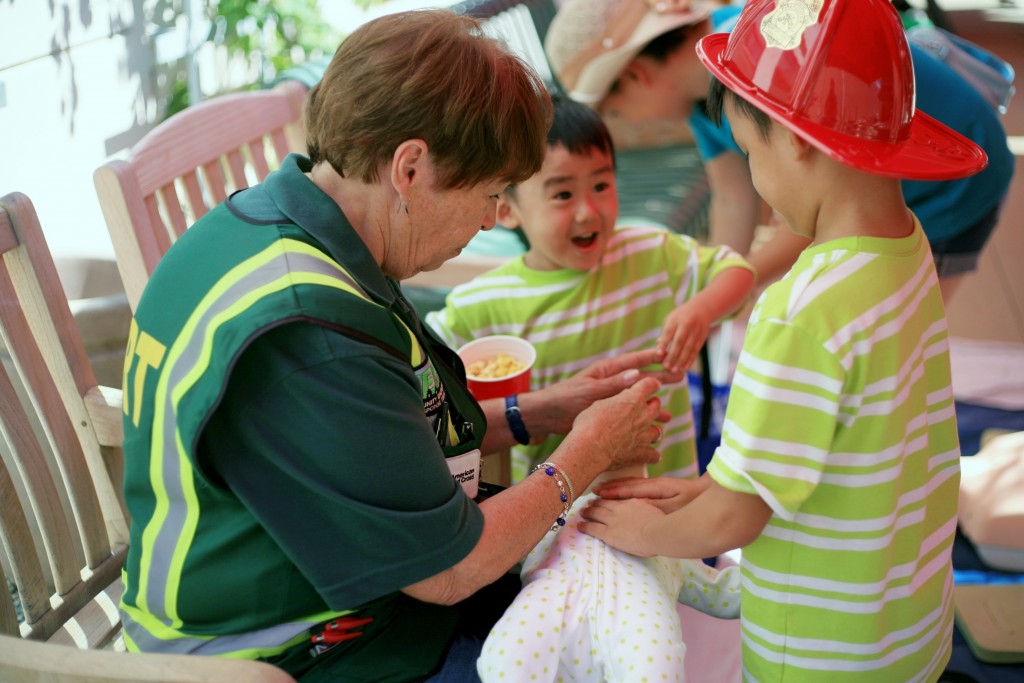 Newport Beach Community Emergency Response Team volunteer Evalie DuMars teaches brothers Luther, 7, (right) and Lukas, 4, Nguyen of Garden Grove how to perform CPR on an infant during Saturday’s 7th Annual Disaster Preparedness Expo. — Photo by Sara Hall ©