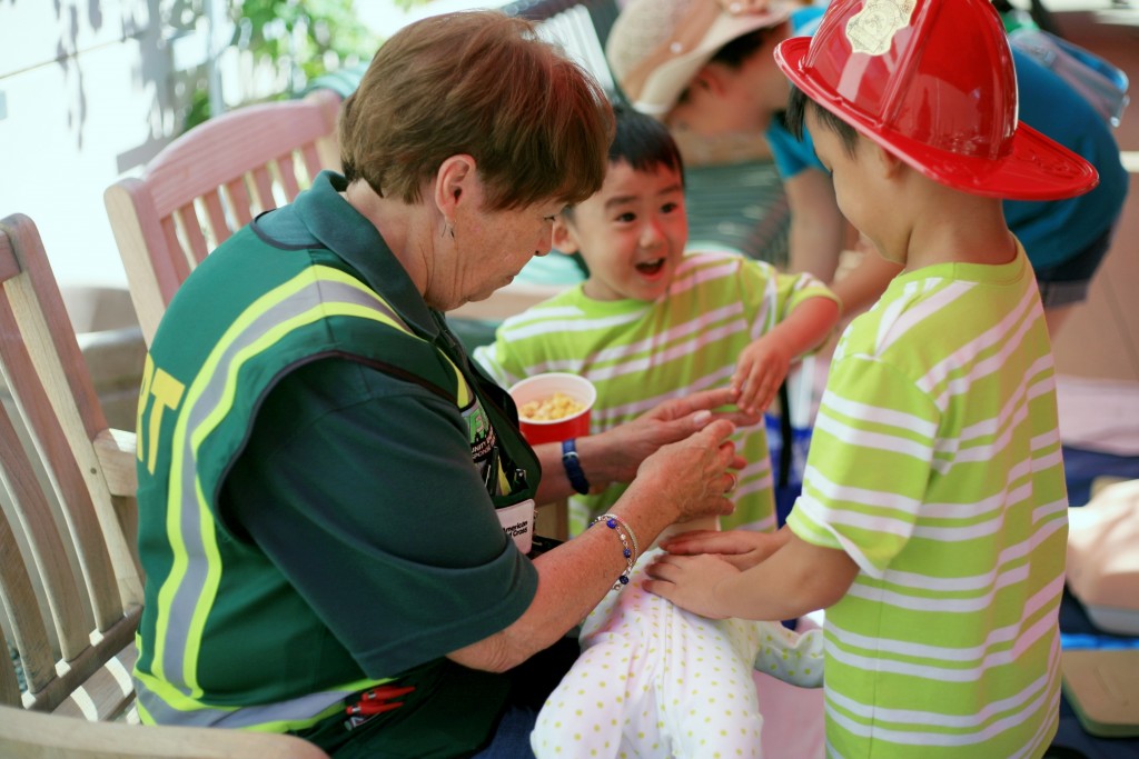 Newport Beach Community Emergency Response Team volunteer Evalie DuMars teaches brothers Luther, 7, (right) and Lukas, 4, Nguyen of Garden Grove how to perform CPR on an infant during Saturday’s 7th Annual Disaster Preparedness Expo.  — Photo by Sara Hall ©