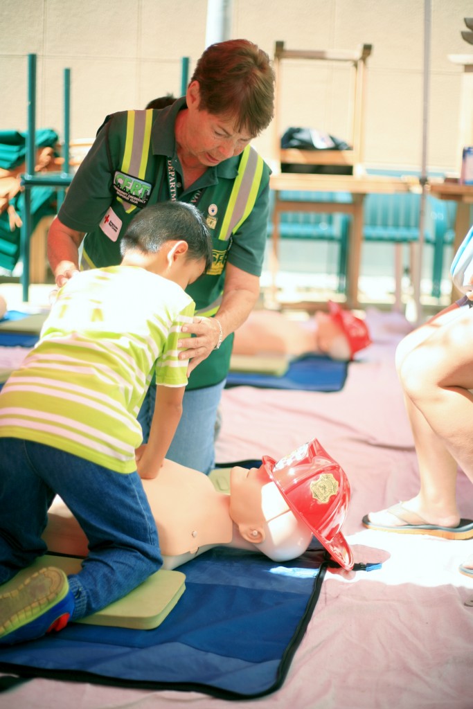 Newport Beach CERT volunteer Marilyn Broughton teaches Luther Nguyen, 7, of Garden Grove how to perform CPR during Saturday’s Preparedness Expo. — Photo by Sara Hall ©