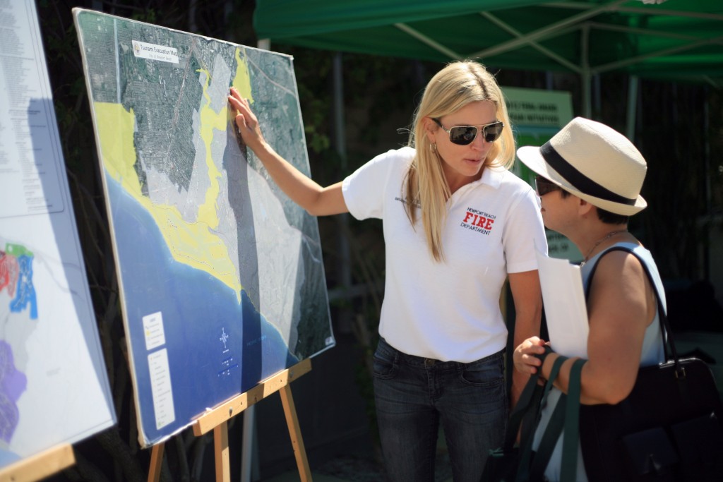 Newport Beach Emergency Services Coordinator Katie Eing explains the city’s tsunami evacuation map to expo attendees.  — Photo by Sara Hall ©