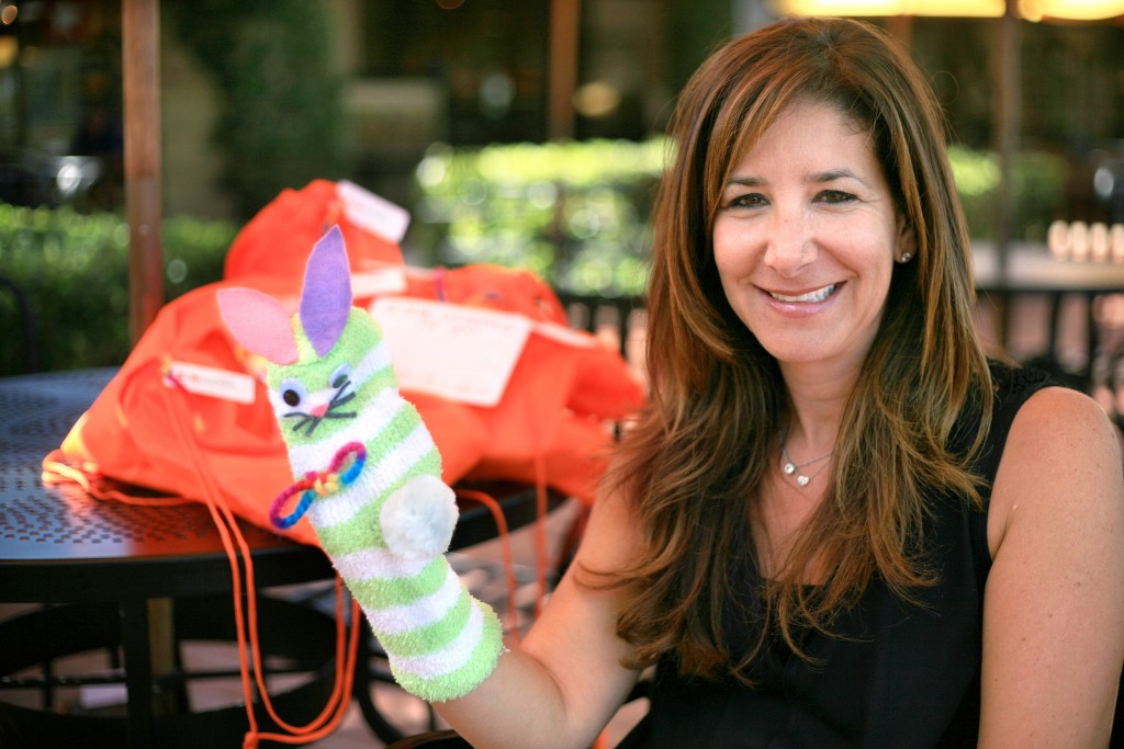 Project Solemates founder Leigh Donaldson Carman with a finished sock puppet. — Photo by Sara Hall ©