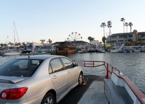 Balboa Ferry prepares to dock at the Balboa Fun Zone, a popular destination for tourists.