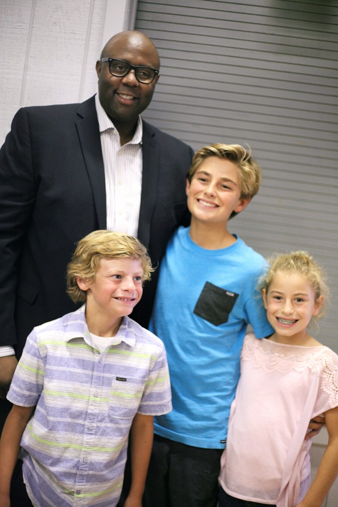 (clockwise, from top left) Retail expert Freddy Cameron poses for photos with the McKenna siblings Jack Courtney, and Colin. — Photo by Sara Hall ©