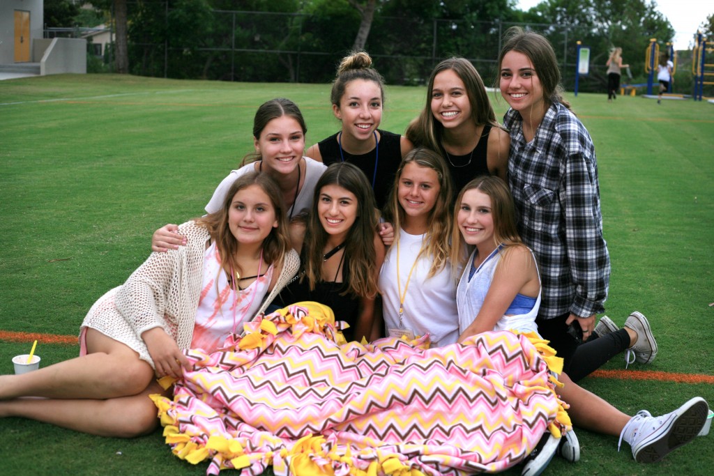 National Charity League girls pose for a photo with a blanket they made at Philanthropy Faire (top row, left to right) Corona del Mar freshmen Ellie Gehl and Kate Wirta, both 14, and sophomores Lauren Griffin, 16, also from CdM, and Liz Prado, 15, from Mater Dei. (Bottom row, left to right) Freshmen Mary Beeker from Mater Dei and Isabella DiGiorgio, Tessa Montgomery, and Natalie Young from CdM, all 14. — Photo by Sara Hall ©