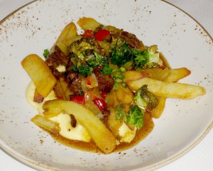 “Philadelphia,” a cheesesteak dish with oxtail, house made cheese whiz, and Kennebec fries