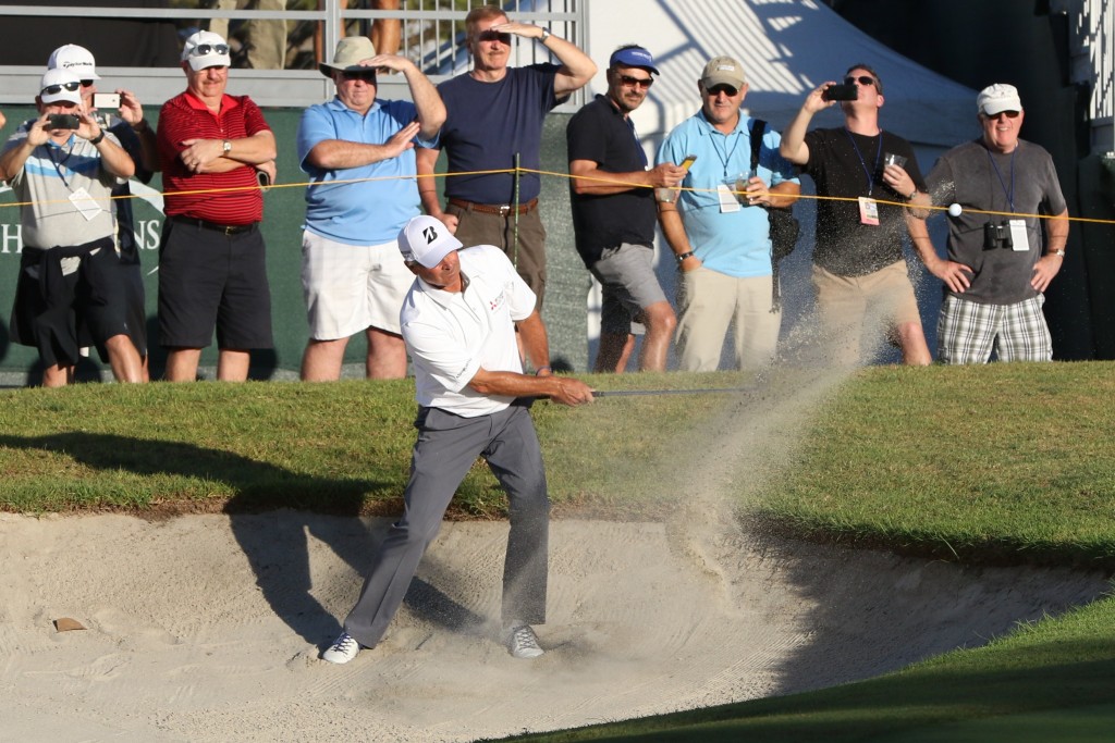 : Newport Beach resident Fred Couples blasts his way out of a sand trap