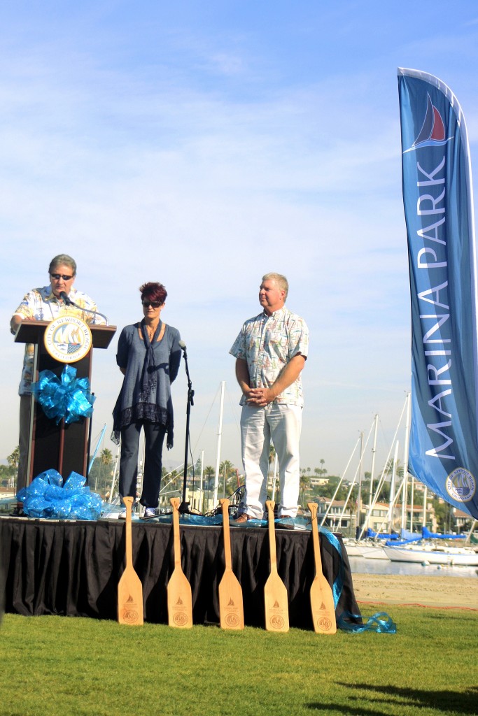 Councilman and recent Mayor Ed Selich speaks during the grand opening ceremony for Marina Park as Recreation and Senior Services Director Laura Detweiler and Public Works Director Dave Webb look on. — Photo by Sara Hall ©