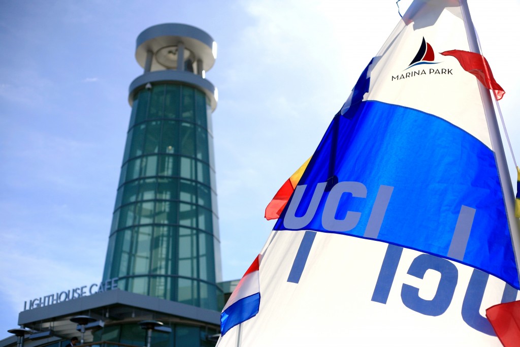 The sail of a University of California, Irvine, Marina Park boat flaps in the wind in front of the Lighthouse Cafe at Marina Park. — Photo by Sara Hall ©