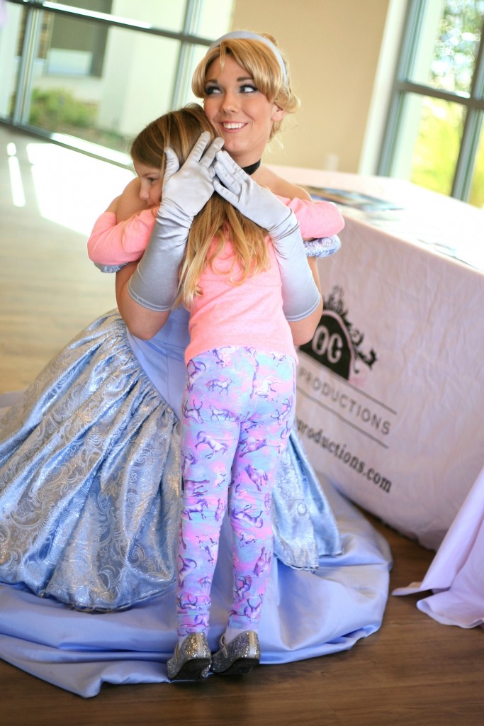 Caroline Corum, 4, gets a hug from Cinderella at the Marina Park event on Saturday. Her grandmother, Susan, lives on the peninsula. — Photo by Sara Hall ©