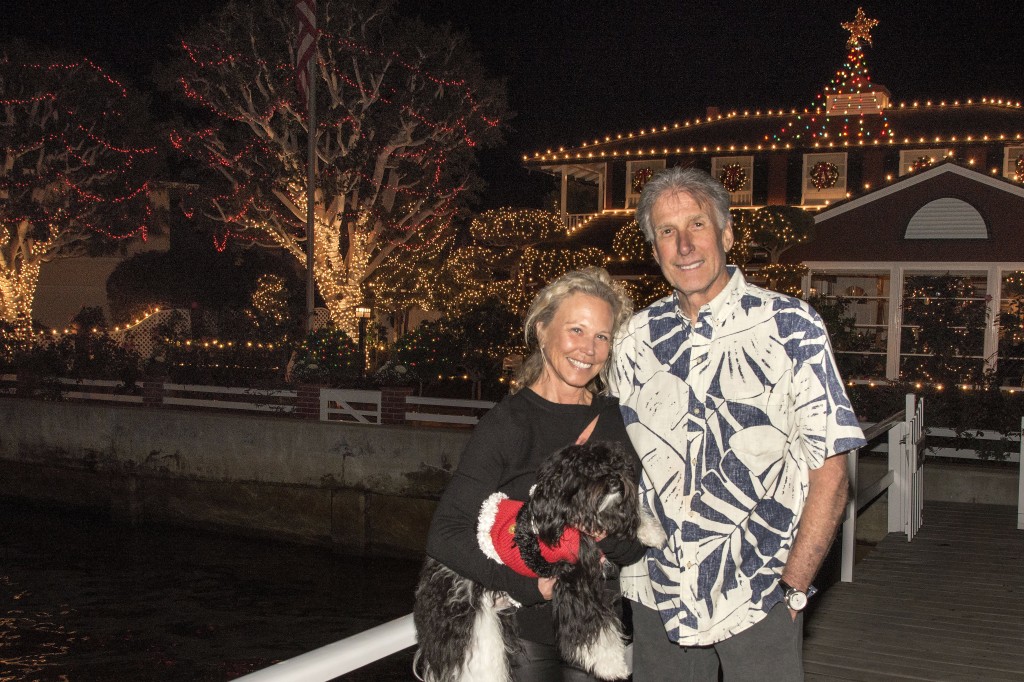 Jim and Judy Busby, with their dog, Henry, in front of their home. — Photo by Charles Weinberg ©