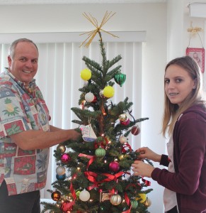 Rob Stewart and his daughter Sienna decorate a tree