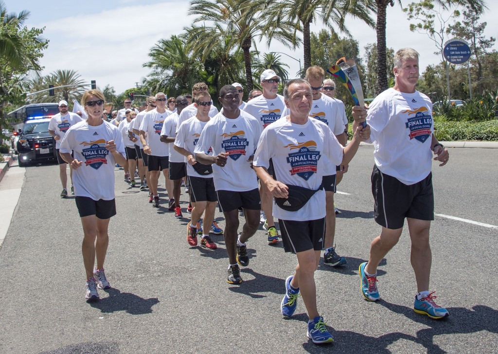 The Special Olympics Flame of Hope is carried along Coast highway through Corona del Mar — Photo by Charles Weinberg©