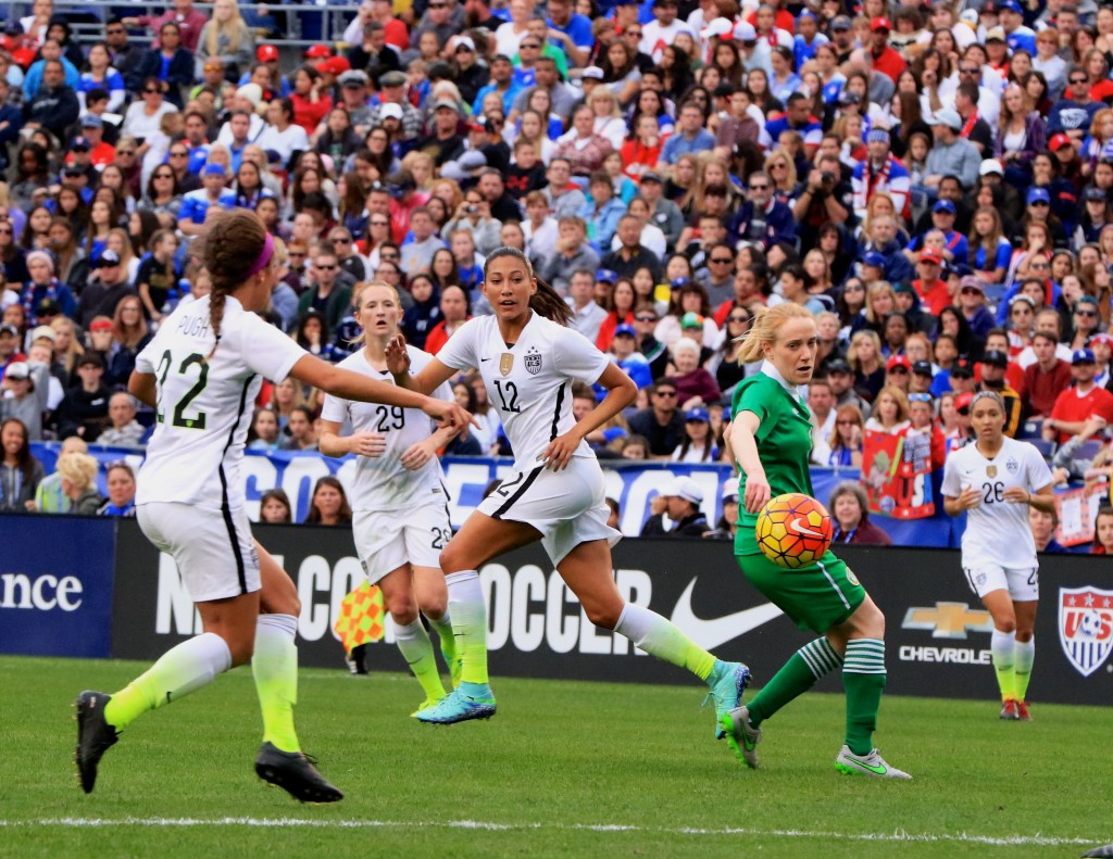 U.S. Women's National Team soccer player and 2015 Newport Beach Christmas Boat Parade Grand Marshal Christen Press (center, #12) makes a move during a Jan. 23 game against Republic of Ireland. — Photo by Jim Collins ©