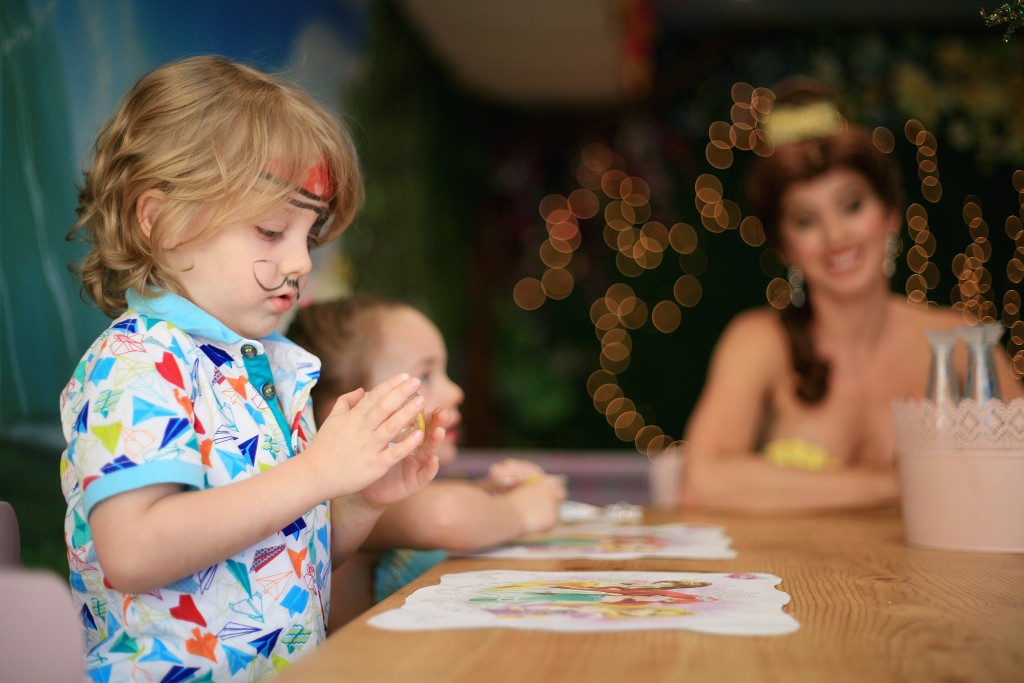 Landon Martin, 4, works on his bracelet as Princess Belle looks on during craft time at Once Upon an Island. — Photo by Sara Hall ©