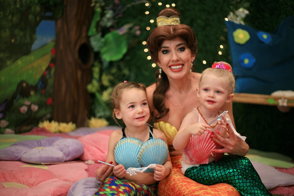 Mini mermaids (left to right) Skylar Amirpur, 3, and Berlin Martin, 2, pose for photos with Princess Belle (transformed into a mermaid). — Photo by Sara Hall ©