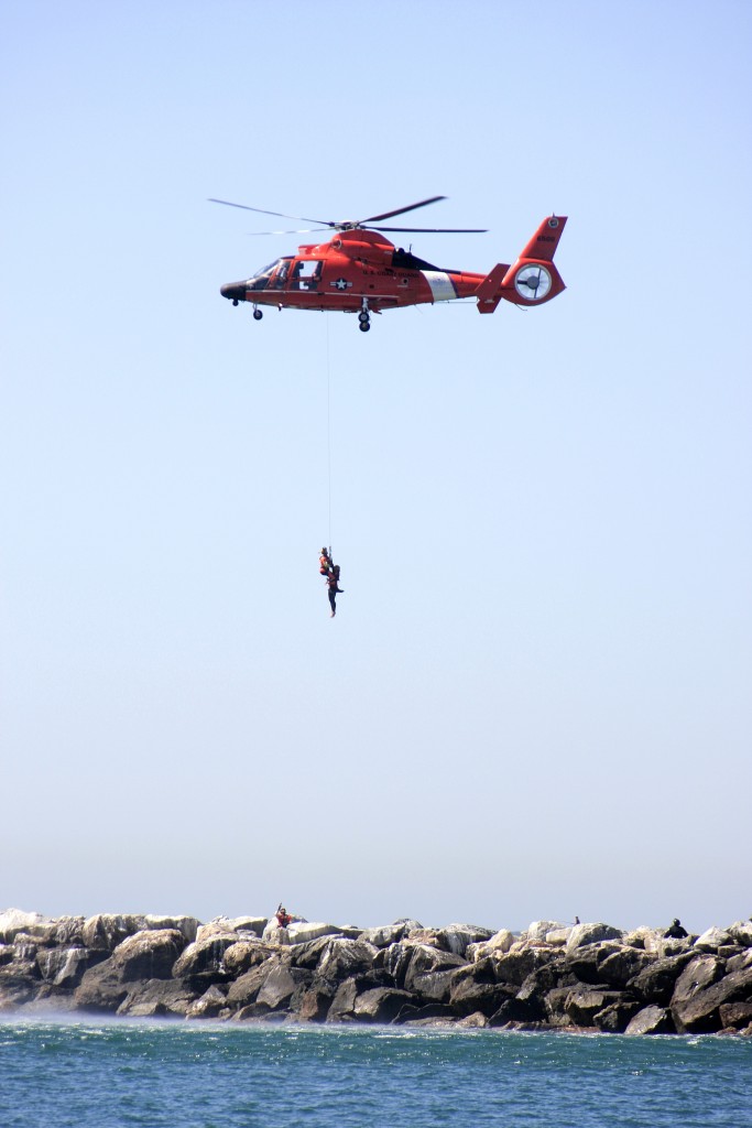 A U.S, Coast Guard helicopter makes a rescue off the jetty near Corona del Mar State Beach during the maritime disaster drill on Wednesday. — Photo by Sara Hall ©