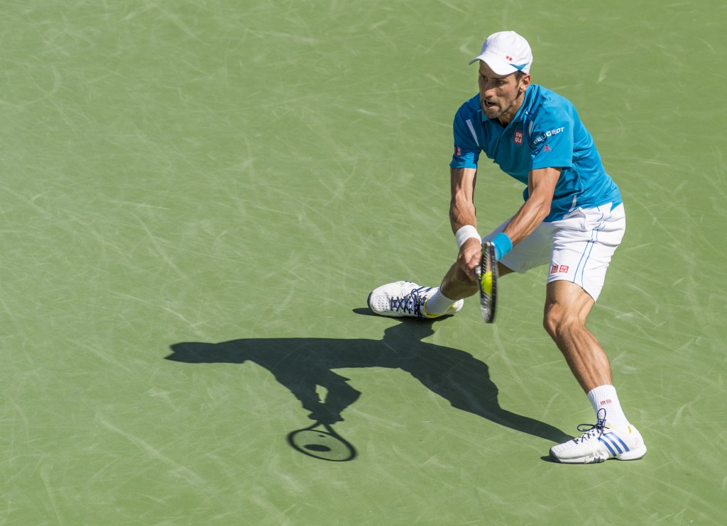 Novak Djokovic hits the ball during a match as he claimed his fifth BNP title. — Photo by Lawrence Sherwin © 