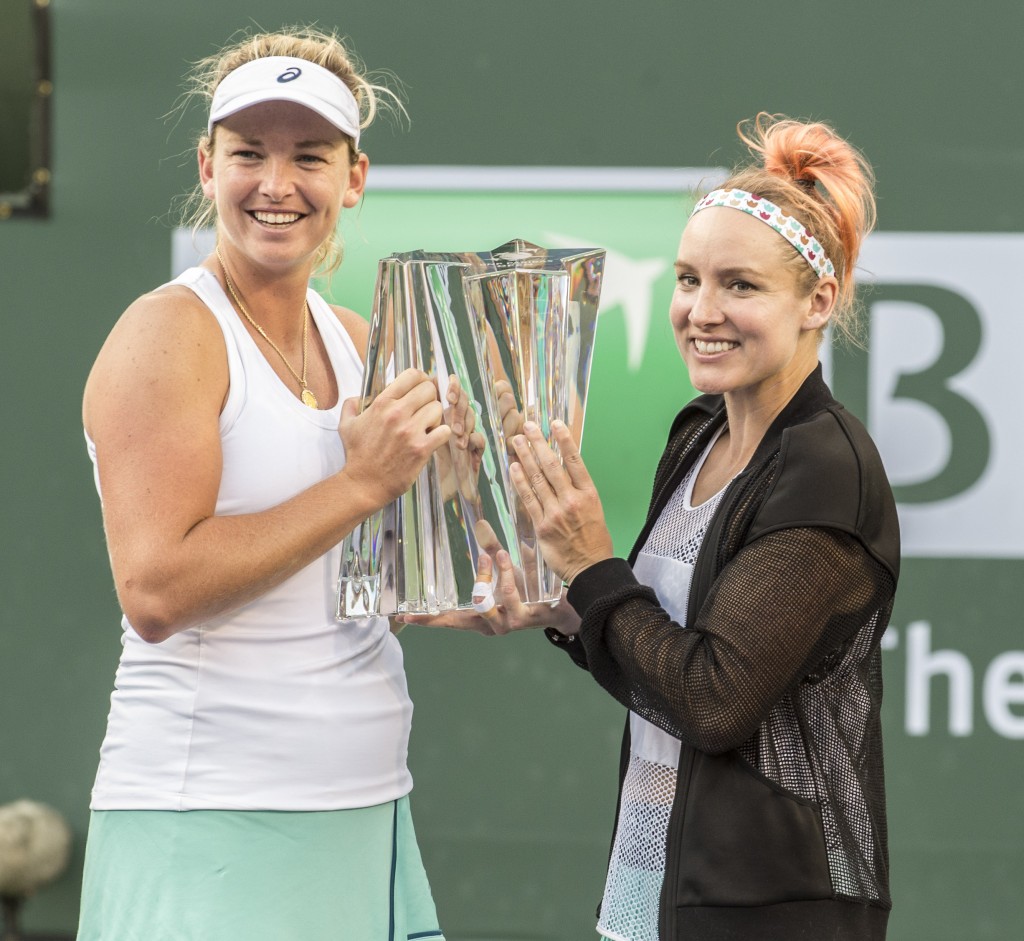 Coco Vandeweghe and Bethanie Mattek-Sands, the women's doubles champions, pose for photos with their trophy. — Photo by Lawrence Sherwin © 