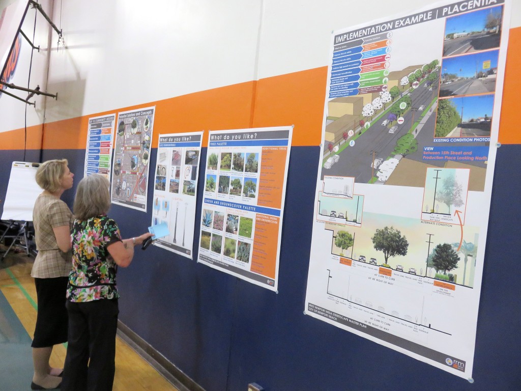 Resident Dorothy Kraus (right) and Newport Beach Community Development Director Kim Brandt look at examples for possible elements in the West Newport Mesa Streetscape Master Plan during a public workshop on Wednesday. — Photo by Sara Hall ©