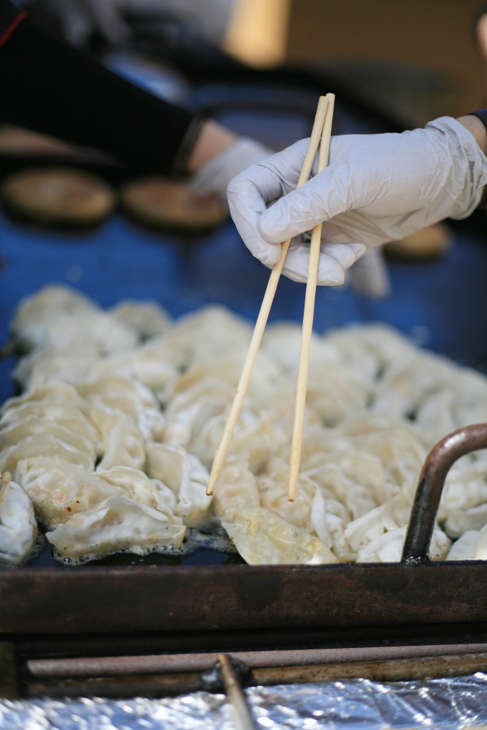 Parent volunteers cook chicken dumplings at the China food booth. — Photo by Sara Hall ©