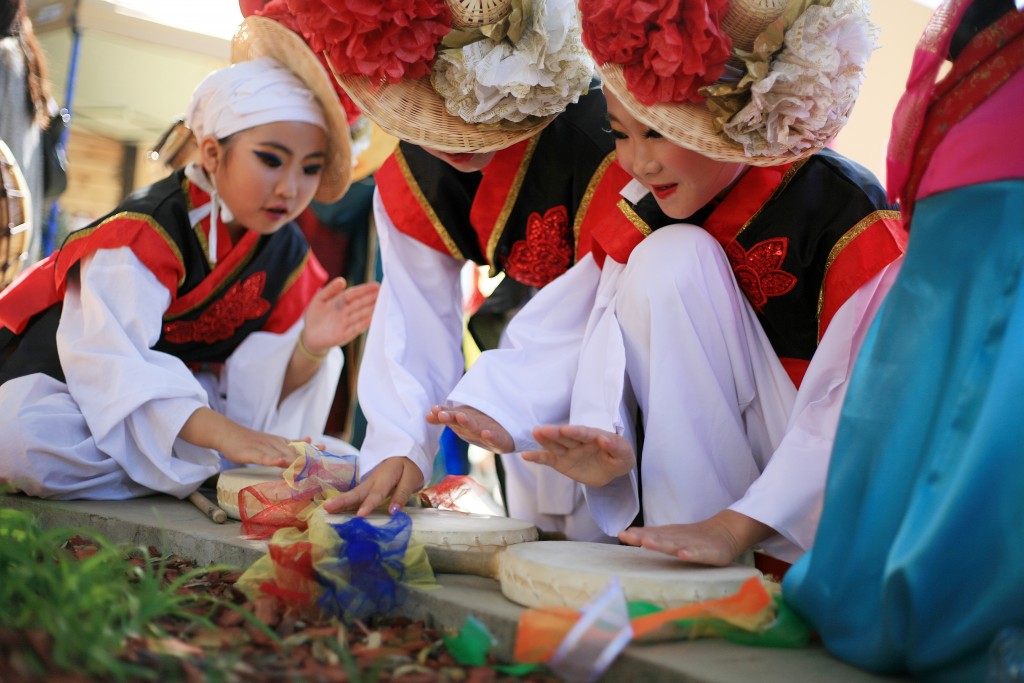 Korean Nongak dancers from KAYPA practice their moves before heading on stage at the Sage Hill Multicultural Fair on Saturday. — Photo by Sara Hall ©