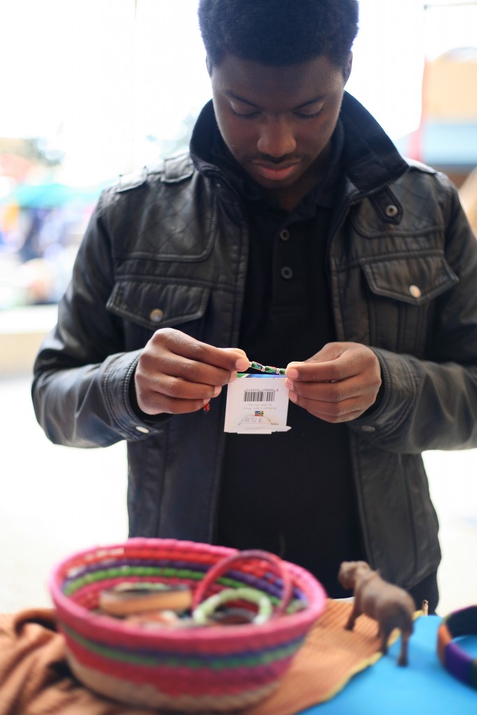 Laguna Niguel student Devonte Boos of 100 Black Men organization checks out some Tanzanian bracelets at the Ethnic Bazaar at the fair. — Photo by Sara Hall ©