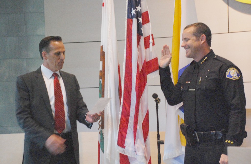 Jon Lewis gets sworn in as the new Newport Beach Police Department chief by the outgoing, retired chief Jay Johnson. — Photo by Daniel Langhorne ©