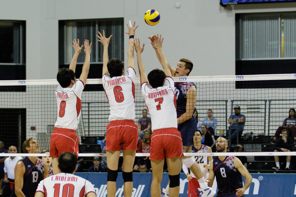 U.S. player Thomas Jaeschke hits the ball over three Japan players during the match. — Photo by Jim Collins ©