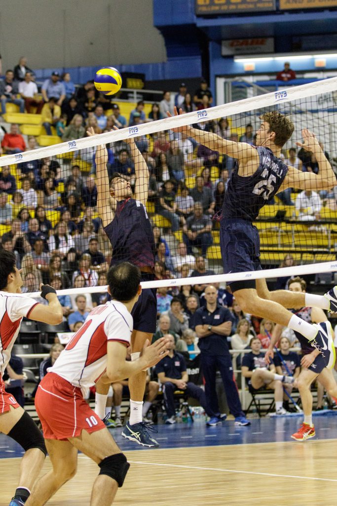 U.S. player Kawika Shoji (#7) sets up the ball as his teammate Dan McDonnell (#25) leaps to spike it against Japan. — Photo by Jim Collins ©