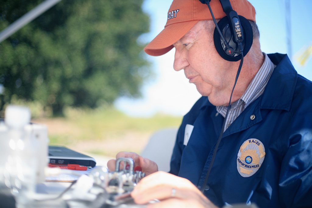 RACES member Bob Carlson sends a Morse code message during ARRL Field Day on Saturday. He had connected with the Belgium United Nations earlier in the day. — Photo by Sara Hall ©