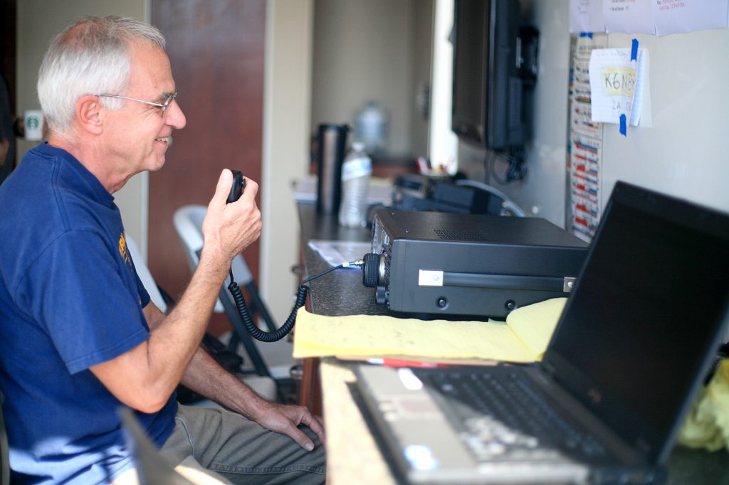 RACES member Bruce Moricca works the radio during the event on Saturday. — Photo by Sara Hall ©