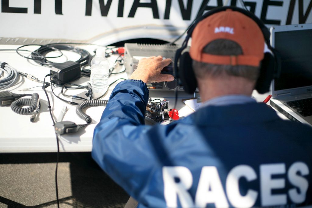 RACES member Bob Carlson sends a Morse code message during ARRL Field Day on Saturday. He had connected with the Belgium United Nations earlier in the day. — Photo by Sara Hall ©