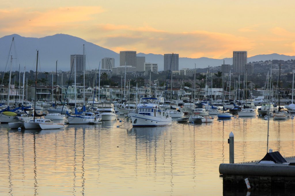 The sun rises over the moorings in Newport Harbor.  — Photo by Sara Hall ©