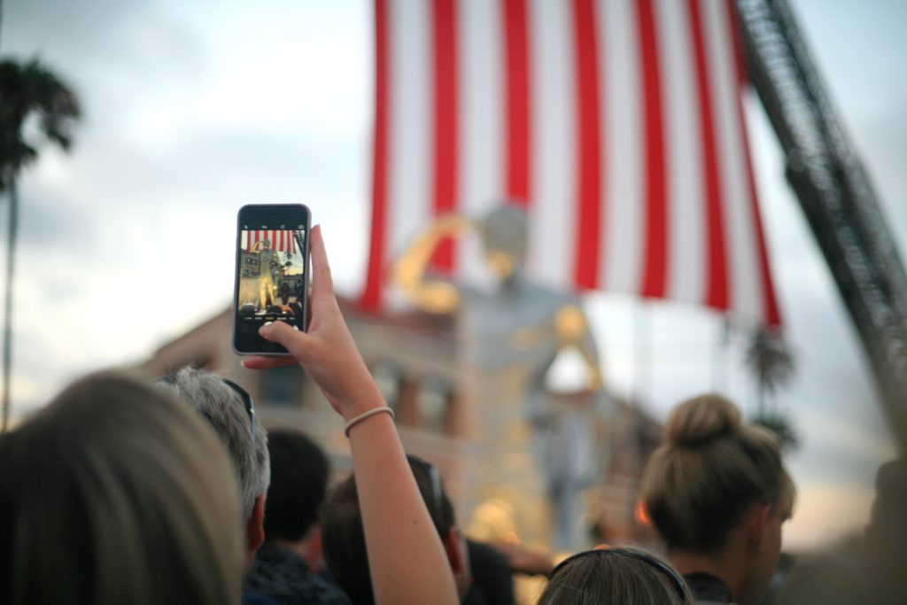 People take photos of the statue after the unveiling. — Photo by Sara Hall ©