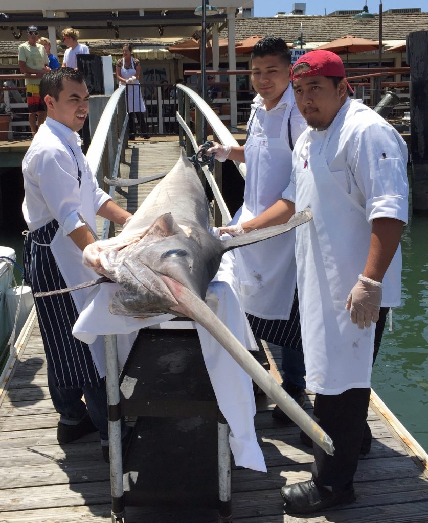 The Bluewater Grill chefs prepare to bring the swordfish into the restaurant. — Courtesy Bluewater Grill ©