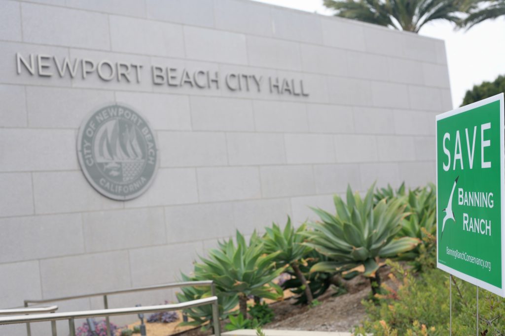 A sign to save Banning Ranch posted in front of the Newport Beach civic center, where the CCC meeting was held, on Wednesday. — Photo by Sara Hall ©