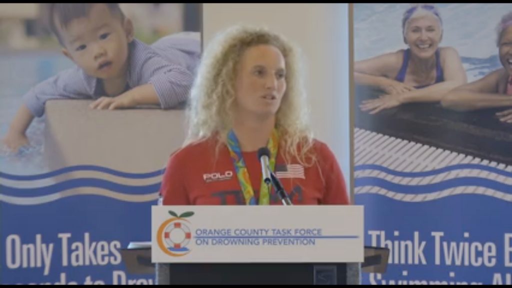 Newport Beach resident and 2016 Olympics Water Polo Gold Medalist Kaleigh Gilchrist talks about water safety at an Orange County Task Force on Drowning Prevention event on Wednesday. — Screen shot from Orange County Fire Authority video