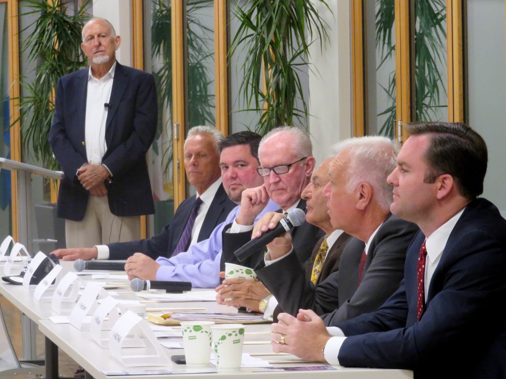 Moderator Tom Johnson (far left, back) listens as (left to right) Brad Avery for District 2, Mike Glenn and Jeff Herdman for District 5, and Fred Ameri, Phil Greer, and Will O’Neill, all for District 7, discuss the issues during the Central Newport Beach Community Association’s Newport Beach City Council candidate forum on Wednesday. — Photo by Sara Hall ©