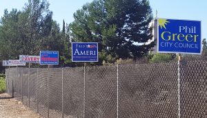 Newport Beach City Council Candidate signs attached to a fence along Bonita Canyon Drive near the 73 Toll Road 