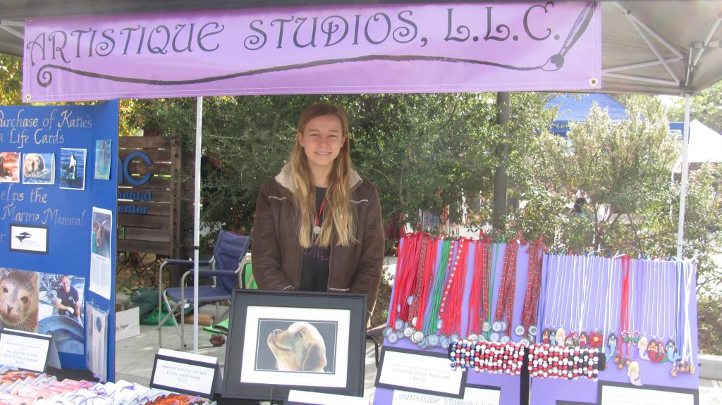 Katie Gerlt in the Artistique Studios craft fair booth. — Photo courtesy Artistique Studios, LLC ©