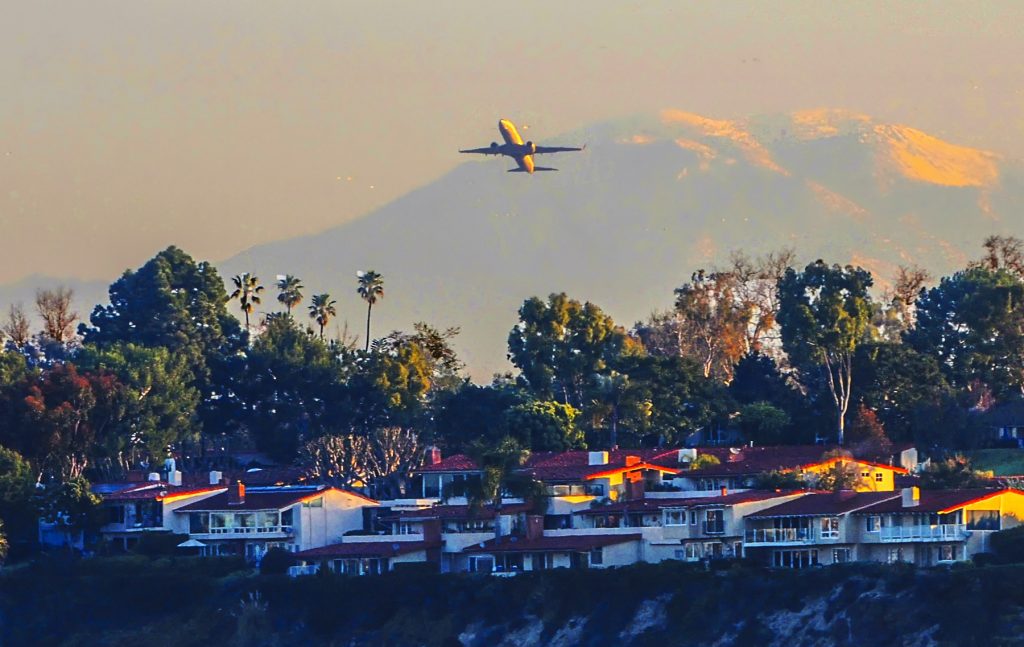 A plane taking off from John Wayne Airport over Newport Back Bay. — NB Indy file photo ©