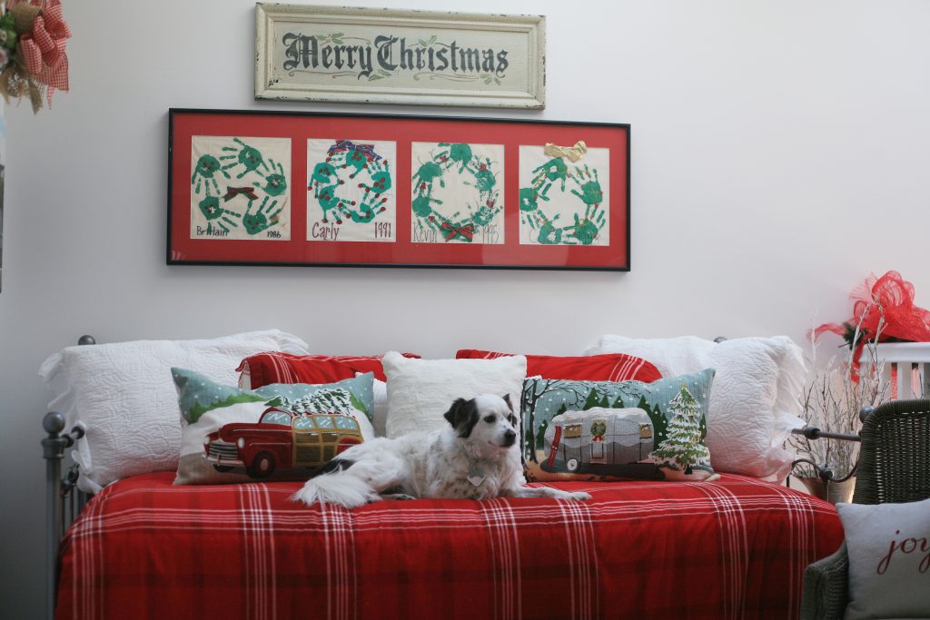 20th Annual Balboa Island Holiday Home Walking Tour homeowner participant Diana Conners’ rescue dog Dewey relaxes on a decorated daybed in Conners S. Bayfront home. — Photo by Sara Hall ©