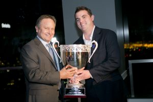 Chase Hoeven presenting The Kaprielian Cup to Commonwealth Partners' Brett Munger for the company's ongoing support. Photo by Carla Rhea