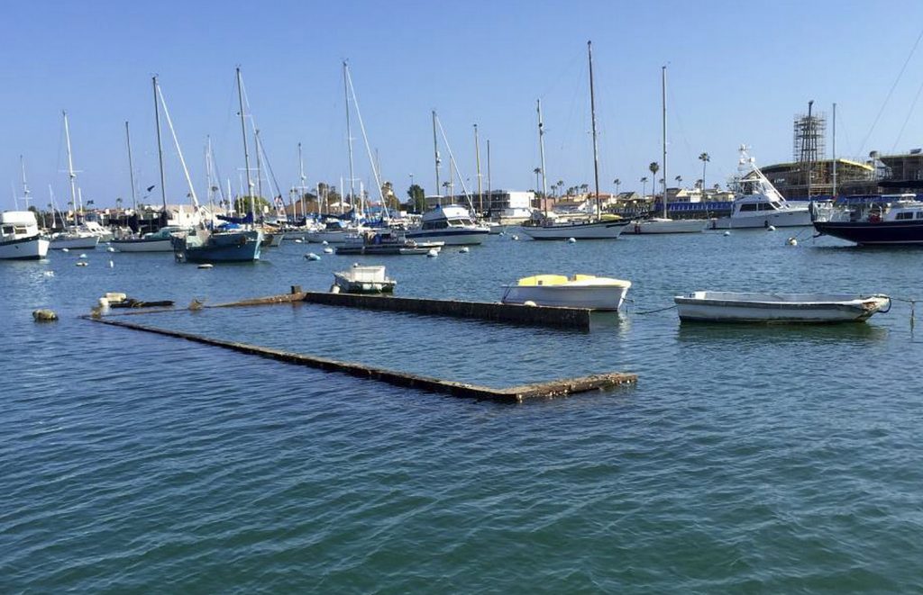 The top portion of the sunken Shellmaker, Inc., scow, Gemini, is still visible in Newport Harbor during low tide. — Photo courtesy the city of Newport Beach ©