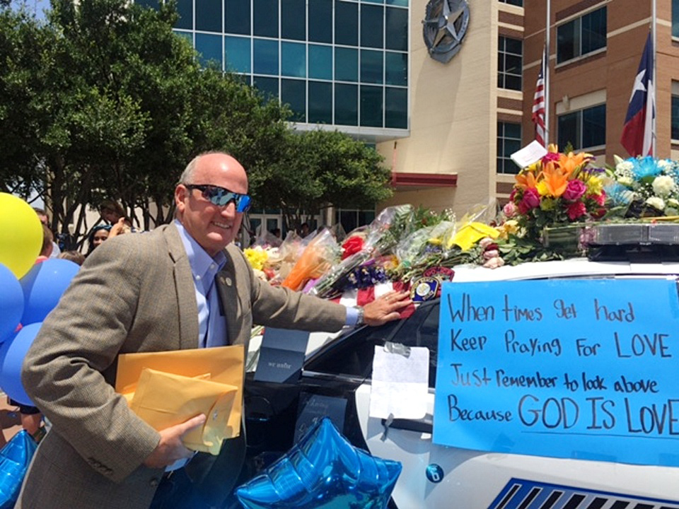 Deputy Chief David McGill visited the makeshift memorial in Dallas on a pre-planned personal trip after the city’s deadly July 7 ambush shooting. He also spoke with officers and police staff. — Photo courtesy David McGill ©