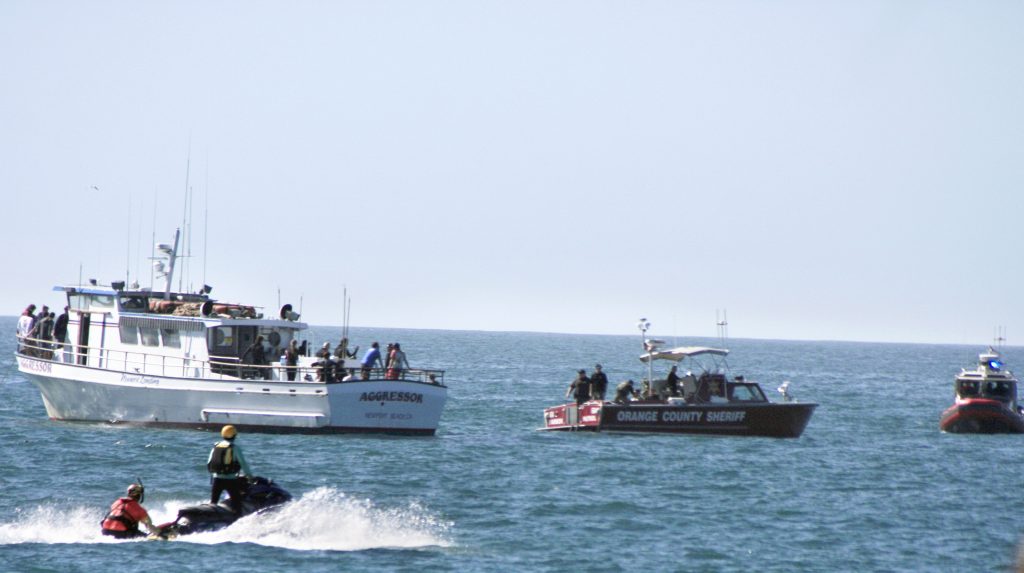 Responding agencies rush to the scene of the disaster scenario drill, surrounding the boat that made the distress call, the Aggressor. — Photo by Sara Hall ©