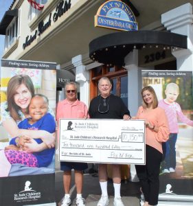 Fly-n-Fish owners Steve & Rick Loomis with Shannon O'Nale of St. Jude Children’s Research Hospital