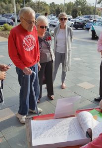 Residents line up in front of the Newport Beach Public Library to sign the Line in the Sand petition against Museum House.