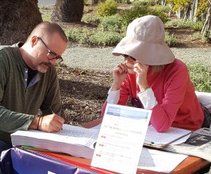 Newport Beach resident signs the Line in the Sand petition against Museum House at the Newport Beach Public Library