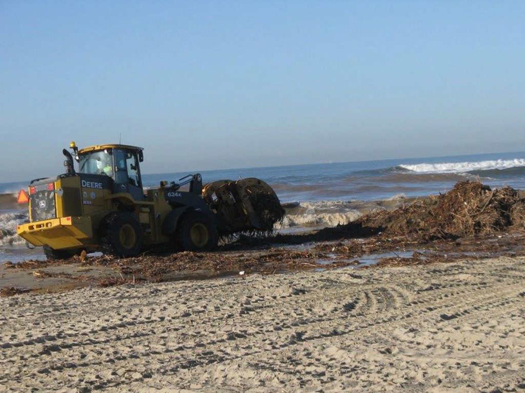 Heavy equipment clears the beach of debris after the stormy weekend. — Photo courtesy Newport Beach Municipal Operations Department ©
